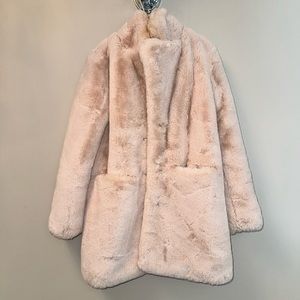 Pale pink faux-fur jacket. Lined. Has pockets.